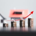 Rising stacks of coins with percentages and arrow symbolizing property value growth from inflation