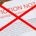 Eviction notice with red cross symbolizing dispute over Section 21 and rent arrears eviction