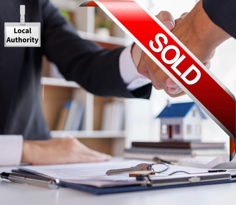Handshake over property sale documents with keys as a local authority finalises the purchase of a tenanted home