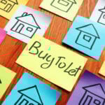 Sticky notes with simple house sketches surrounding a note labelled “Buy To Let,” representing buy-to-let property investing.