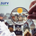 Magnifying glass focusing on house values with UK banknotes and e.surv branding, illustrating falling property prices.