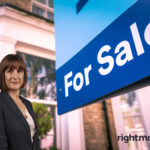 Estate agent standing beside a Rightmove “For Sale” sign outside a home.
