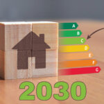 Wooden blocks forming a house beside EPC energy rating chart with 2030 target highlighted.