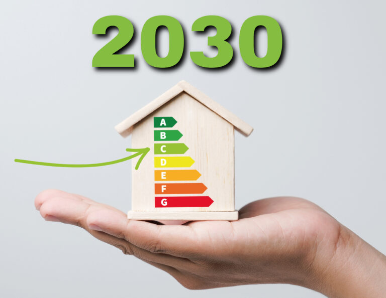 Hand holding a model house with EPC rating chart and 2030 energy efficiency target