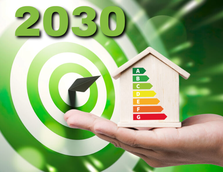 Hand holding energy efficiency house model with EPC rating chart and 2030 target in background
