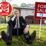 Worried man in front of a house for sale amid debate over Labour’s landlord tax plans