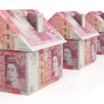 Row of houses made from £50 notes symbolising UK property market value and investment