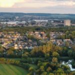 Aerial view of Milton Keynes housing estates surrounded by greenery at sunset