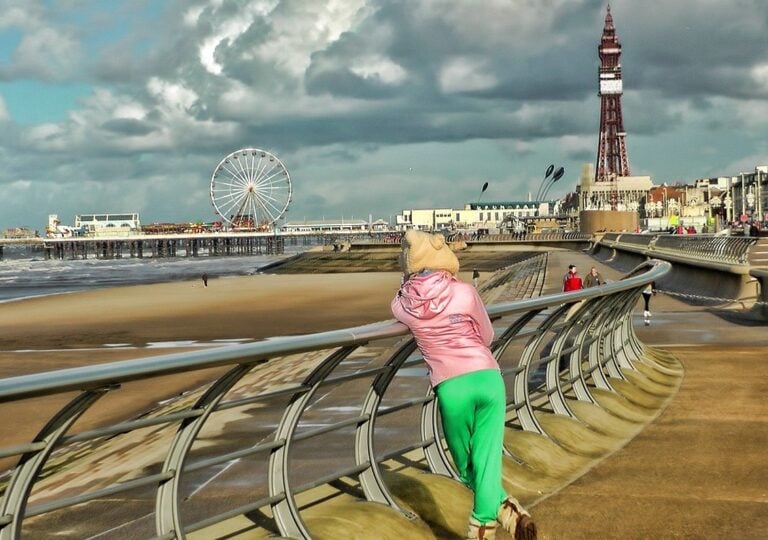 Child overlooking Blackpool beach with tower and pier in view