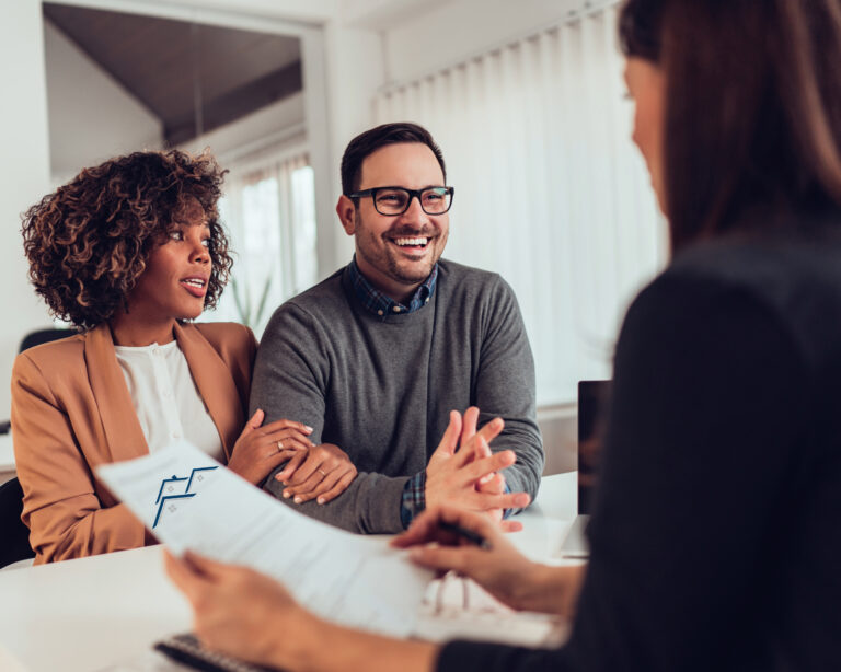 Smiling couple meeting with an agent to discuss property and customer service
