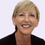 Smiling professional woman representing leadership in social housing regulation