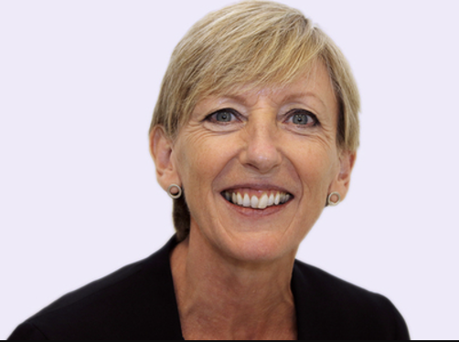 Smiling professional woman representing leadership in social housing regulation