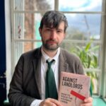 Author holding his book “Against Landlords” discussing UK housing reform.