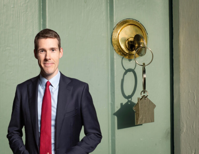 Housing Minister stands beside house key in door discussing Renters’ Rights Bill and landlord sector stability