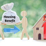 Wooden figures exchange housing benefit bag with house showing rising costs