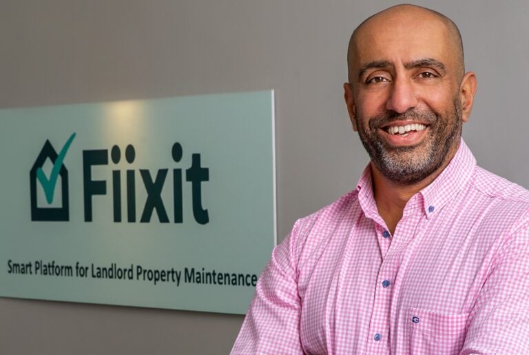 Founder of Fiixit standing beside company logo promoting new landlord maintenance platform
