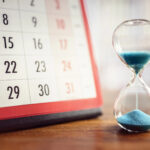 Hourglass beside a calendar symbolising urgency to sell before Stamp Duty deadline