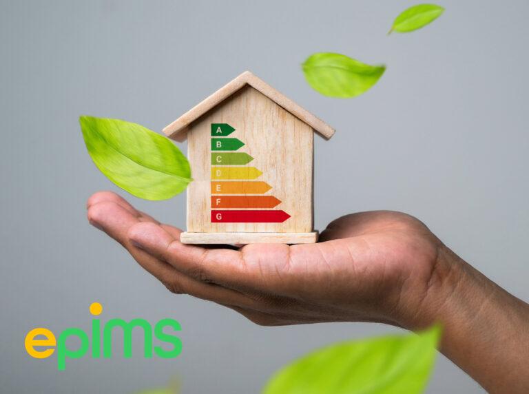 Hand holding a wooden house with EPC energy rating chart and green leaves symbolizing efficiency