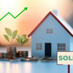 Stacks of coins with plants beside a model house and sold sign, symbolizing rising house prices.