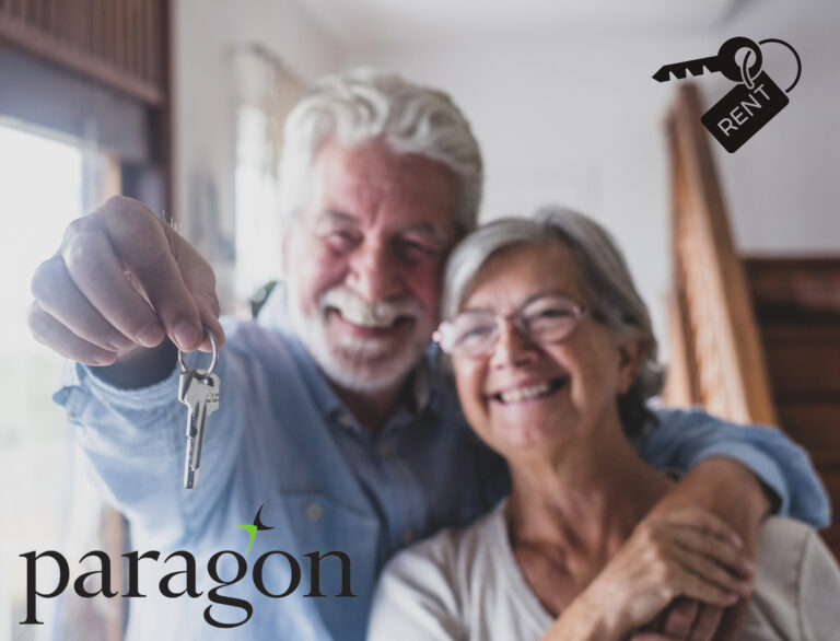 Smiling older couple holding house keys, symbolizing rise in older renters