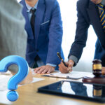 Lawyers reviewing a disputed lease agreement with legal documents and gavel on desk