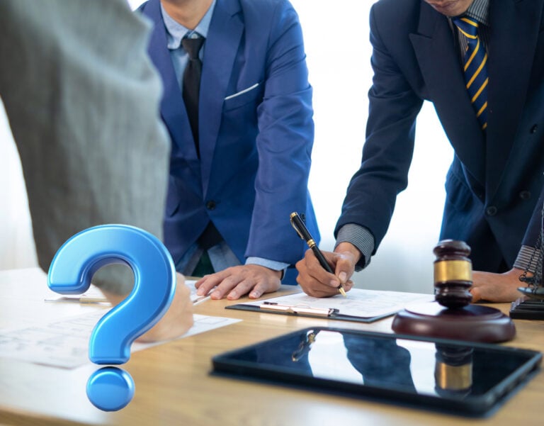 Lawyers reviewing a disputed lease agreement with legal documents and gavel on desk