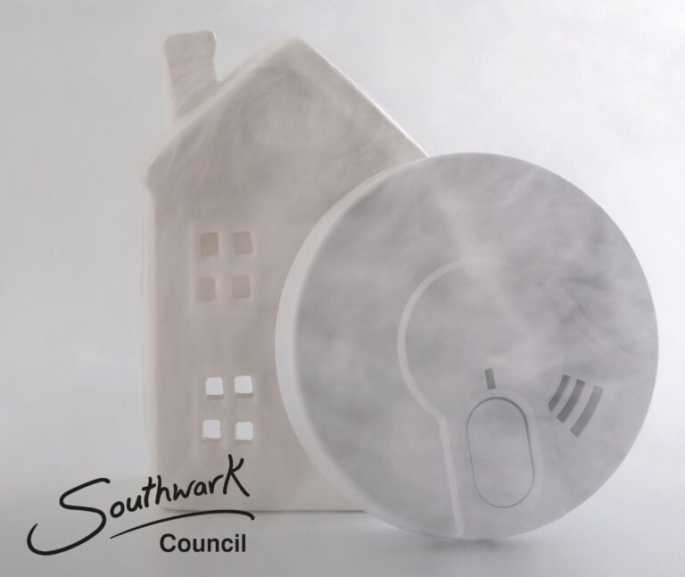 Smoke alarm with smoke and a house symbol highlighting fire safety concerns.