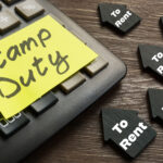 Calculator with stamp duty note and rental property icons.