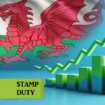 Welsh flag with rising bar chart symbolising stamp duty tax increase on landlords