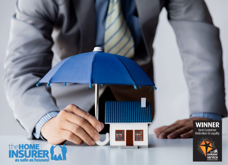 Businessman protecting house model with umbrella, symbolizing landlord insurance coverage.