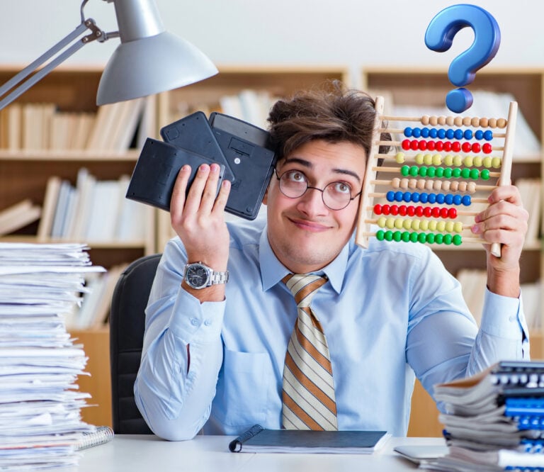 Confused accountant comparing calculators and an abacus while managing paperwork