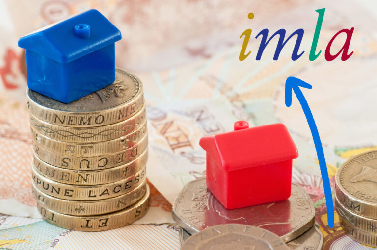Stacked coins with house models symbolizing rising buy-to-let lending forecasts by IMLA.