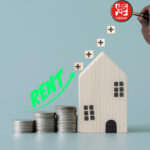 Rising rent costs shown with stacked coins, house model, and Labour Party magnifying glass