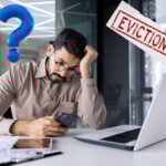 Worried landlord checking phone after serving Section 21 eviction notice