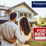 Couple viewing rental home with Hamptons estate agent sign
