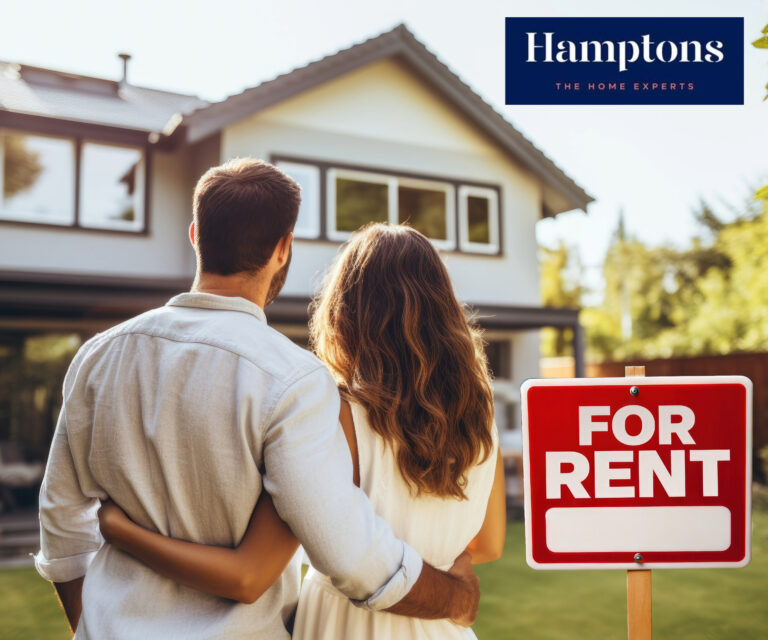 Couple viewing rental home with Hamptons estate agent sign