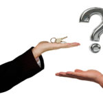 Keys held above open hand with question mark symbolizing tenant landlord dispute