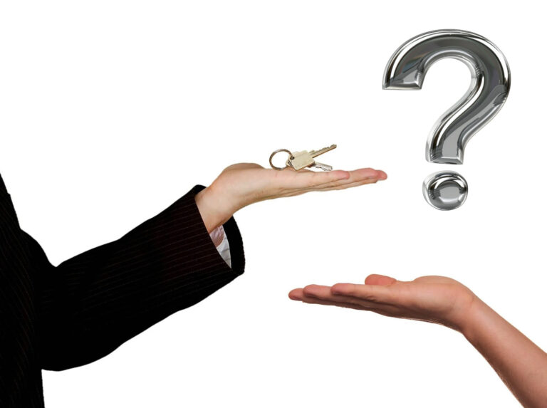 Keys held above open hand with question mark symbolizing tenant landlord dispute