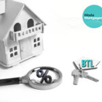 Wooden house, keys with BTL label, and magnifying glass with percent symbol representing buy-to-let mortgages