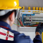 Electrician carrying out wiring inspection under new Northern Ireland landlord safety regulations