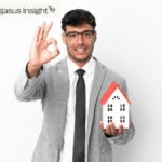 Confident landlord holding house model, symbolizing optimism in rental market despite new legislation.