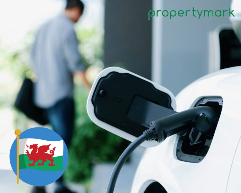 Electric vehicle charging point in use with Welsh policy debate context