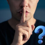 Man holding finger to lips with question mark symbol, representing tenant rights in leaseholder meetings