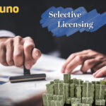 Hand stamping approval with cash stacks symbolizing costs of selective licensing for landlords