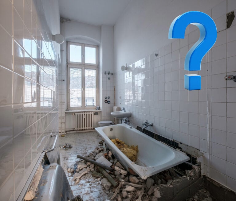 Damaged bathroom with debris and missing fixtures under renovation dispute