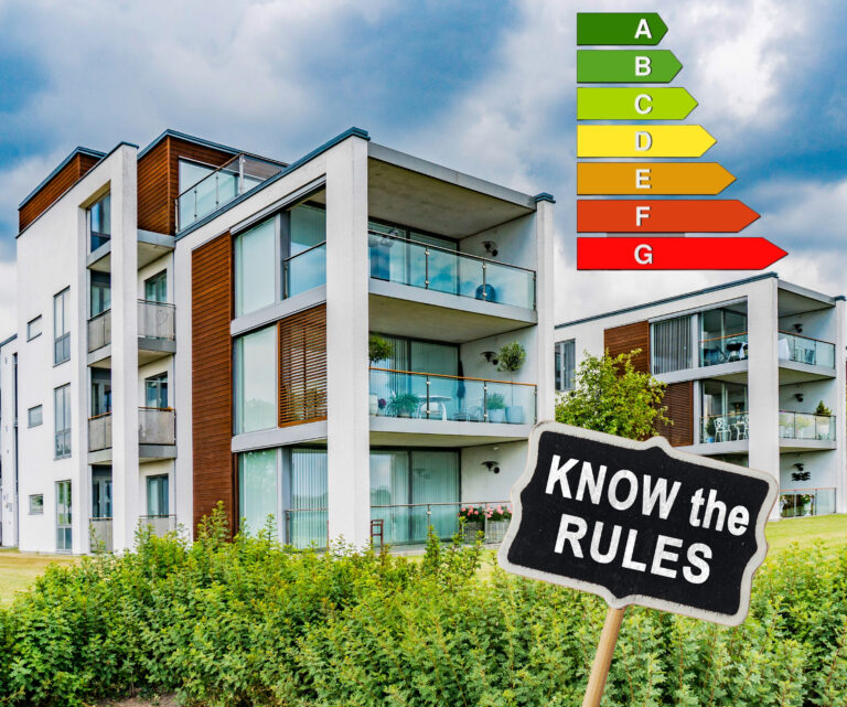Modern apartment block with energy efficiency rating chart and sign urging landlords to know EPC rules