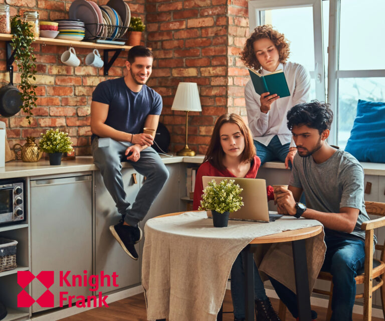 Students collaborating in shared accommodation kitchen space