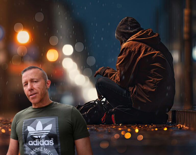 Man standing in front of a homeless person sitting on a rainy city street at night