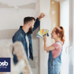 Couple choosing paint colors for decorating their rental home.