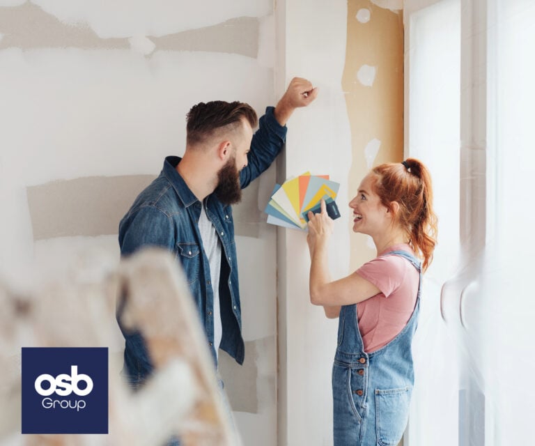 Couple choosing paint colors for decorating their rental home.